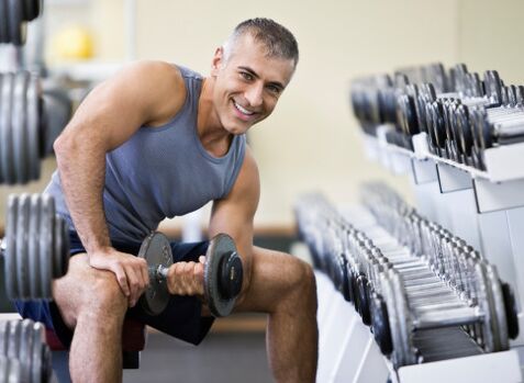 man holding dumbbell