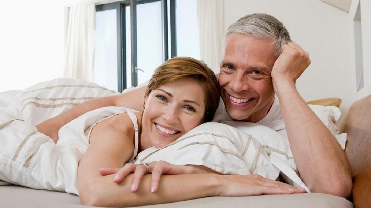 happy married couple in bed